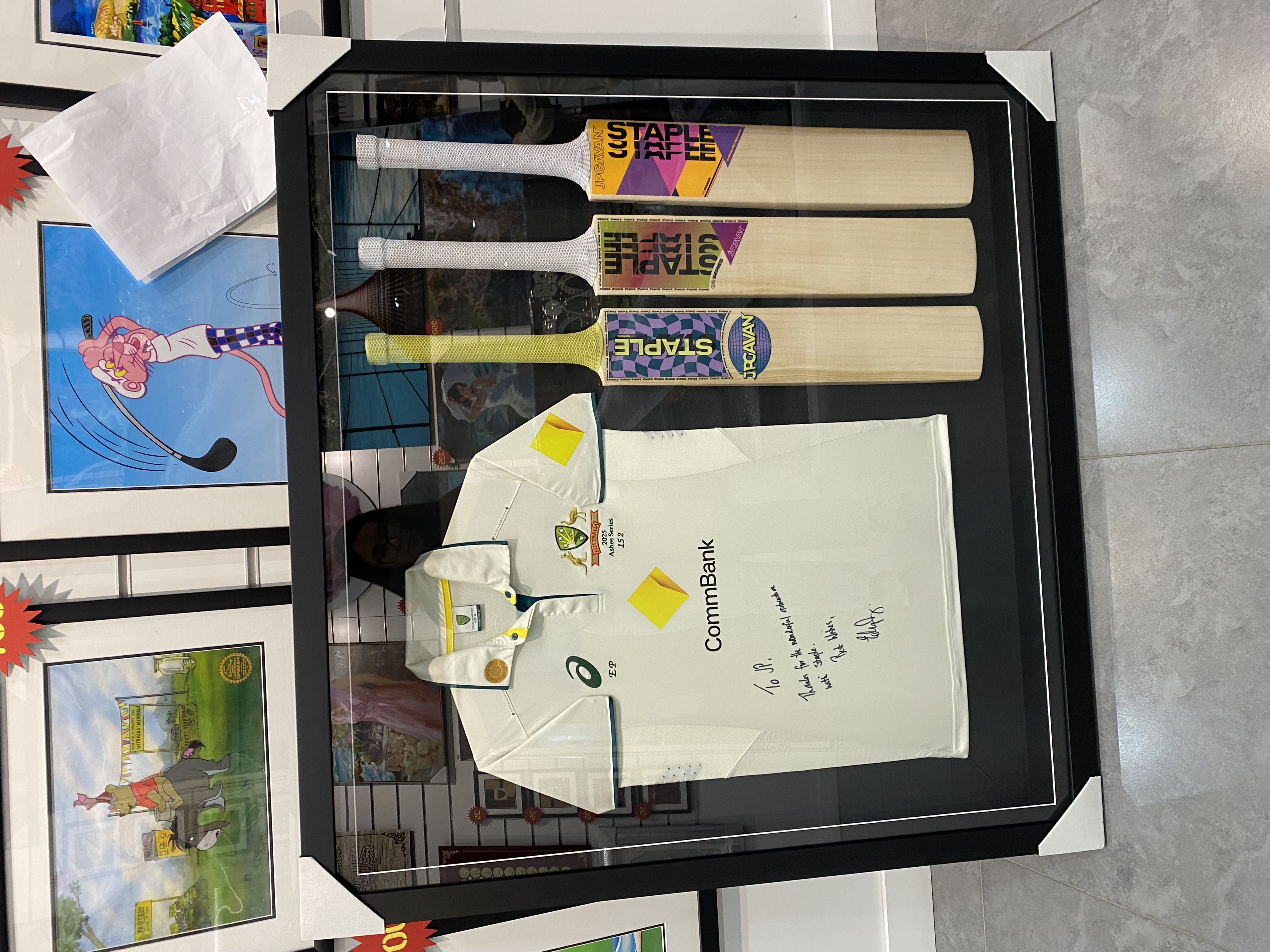 Custom frame showing three cricket bats beside a signed Australian cricket jersey
